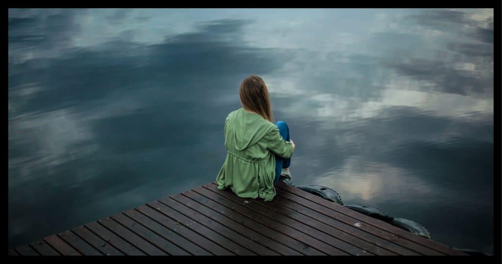 Sitting on the dock.